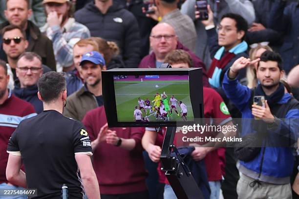 Referee Chris Kavanagh reviews VAR before disallowing a late goal from Callum Wilson of West Ham United during the Premier League match between West...
