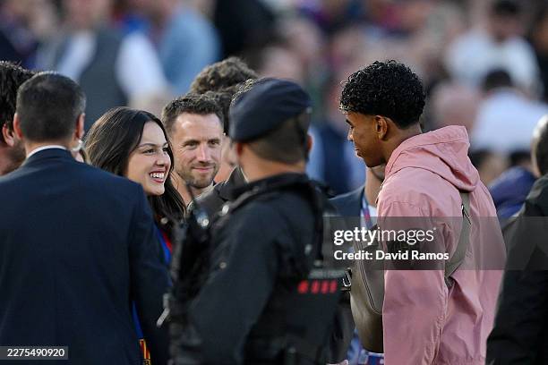 American Singer Olivia Rodrigo interacts with Lamine Yamal of FC Barcelona, who misses the match due to injury, on the touchline prior to the LaLiga...