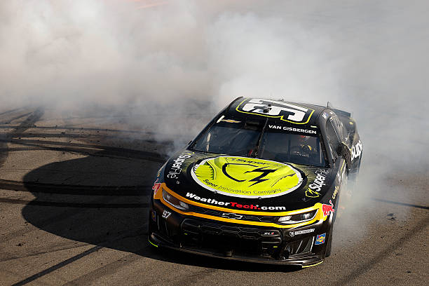 Shane Van Gisbergen, driver of the Superfile Chevrolet, celebrates with a burnout after winning the NASCAR Cup Series Go Bowling at The Glen at...