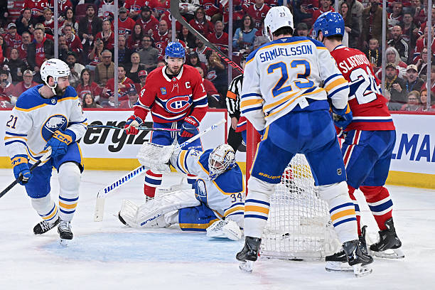 Alex Lyon of the Buffalo Sabres concedes a goal scored by Cole Caufield of the Montreal Canadiens during the second period in Game Three of the...