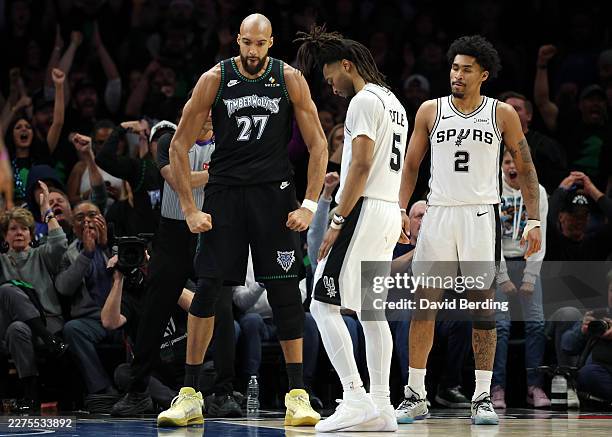 Rudy Gobert of the Minnesota Timberwolves reacts in front of Stephon Castle and Dylan Harper of the San Antonio Spurs during the fourth quarter in...