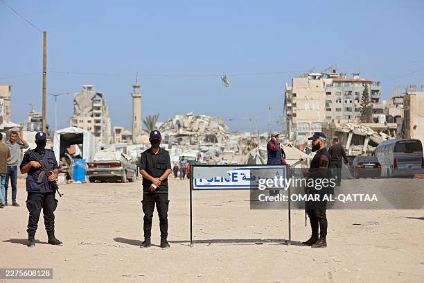 Palestinian militant group Hamas police officers stand guard as people attend the opening of the Fatah party's eighth general conference at Al-Azhar...