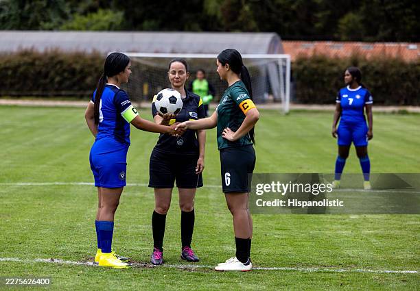 referee handshaking with female soccer players at kick off - club soccer stock pictures, royalty-free photos & images