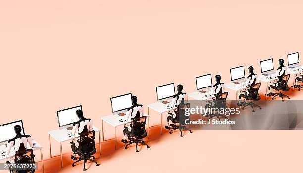 extended row of humanoid robots working at office desks with monitors in soft peach colored studio - deep learning stock pictures, royalty-free photos & images