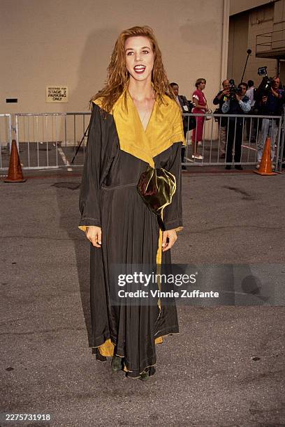 American actress, playwright and singer Carrie Hamilton, wearing a black-and-yellow dress, attends the inaugural MTV Movie Awards at Walt Disney...