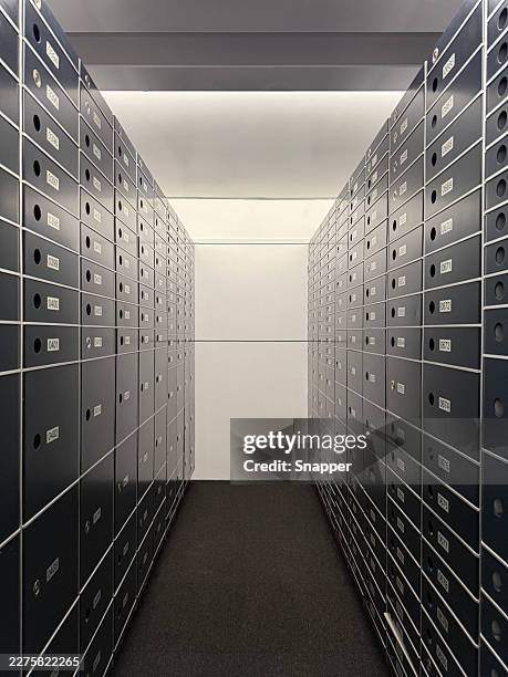 two rows of partly decommissioned safe deposit boxes in a room - locker stock pictures, royalty-free photos & images
