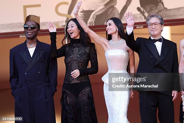 Jury Members Isaach de Bankolé, Chloé Zhao, Demi Moore and Jury President Park Chan-wook attend the opening ceremony and "La Vénus Electrique"...