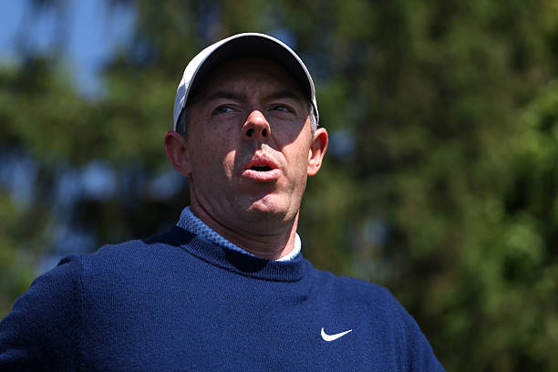 Rory McIlroy of Northern Ireland walks to a cart on the fourth hole during a practice round prior to the PGA Championship at Aronimink Golf Club on...