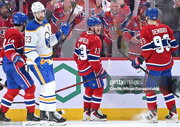 Cole Caufield of the Montreal Canadiens celebrates after scoring a goal against the Buffalo Sabres with Ivan Demidov during the first period in Game...