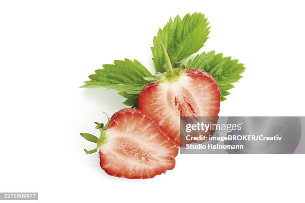 halved strawberries with leaves - red berries explosion stock pictures, royalty-free photos & images