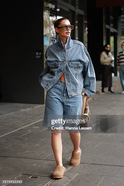 Guest wearing denim jacket, matching shorts, Louis Vuitton bag and ugg slippers outside the NAGNATA show at Australian Fashion Week 2026 on May 13,...
