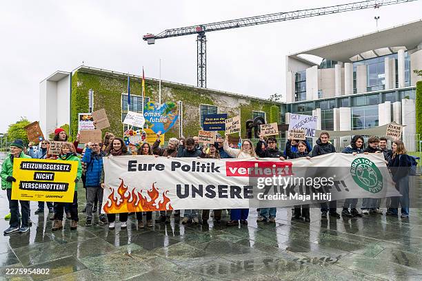 Members of Fridays for Future protest outside the Chancellery during a protest against the building modernization bill on May 13, 2026 in Berlin,...