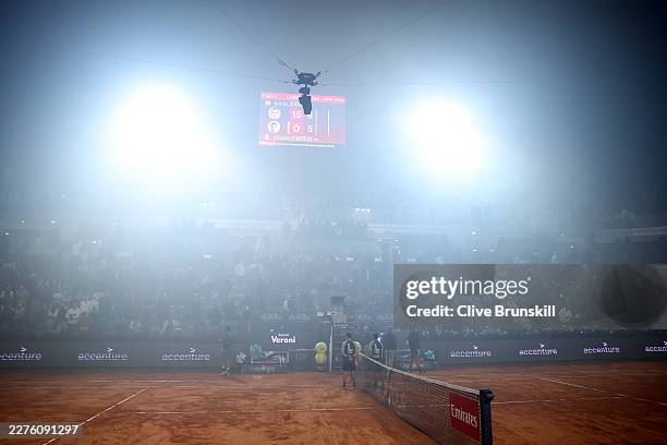 General view of Campo Centrale as smoke from a nearby football match surrounds the court leading to the match being suspended in the Men's Singles...