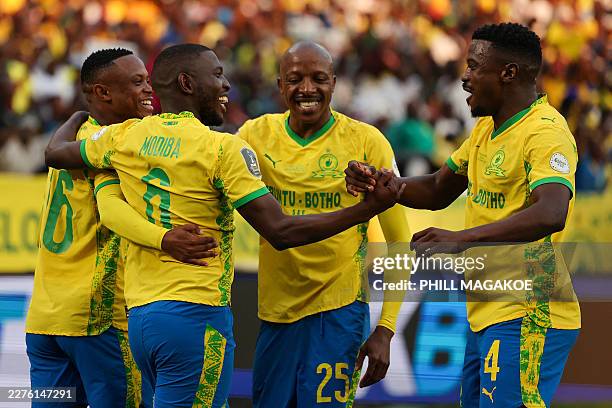 Sundowns' South African defender Aubrey Modiba celebrates with teammates after scoring his team's first goal during the CAF Champions League final...