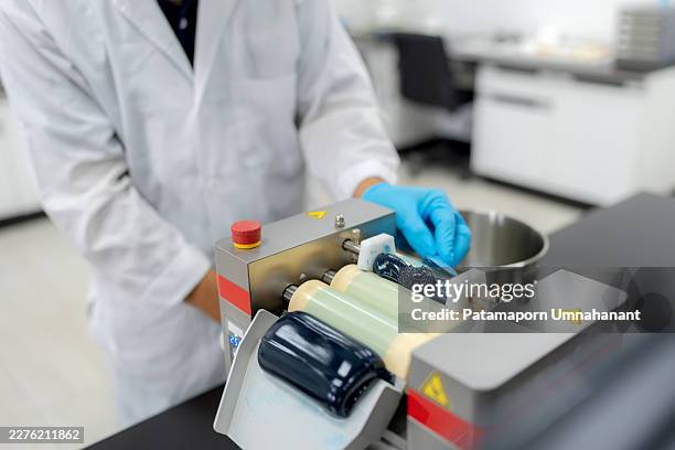 processing formulation additives and grease texturing on a three-roll mill machine. industrial laboratory equipment refining lubricant quality and compounding chemical structures for advanced manufacturing. - ball bearing stock pictures, royalty-free photos & images