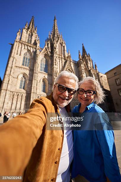 retired couple taking selfie during barcelona holiday - catalonia stock pictures, royalty-free photos & images