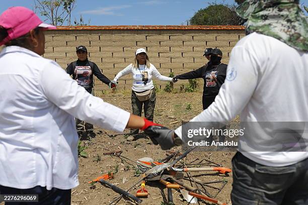 Members of the collectives Searching Hands and Searching Warriors of Jalisco take part in a search operation for missing persons at abandoned houses...