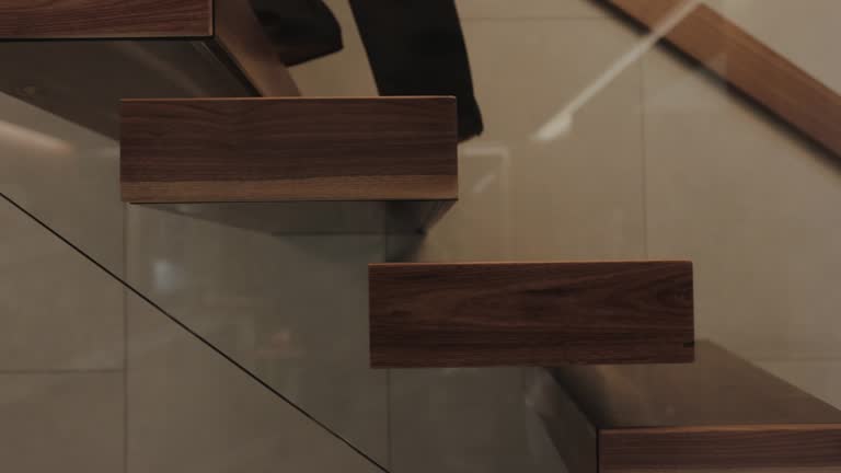 https://media.gettyimages.com/id/2276399361/video/an-elegant-woman-walking-gracefully-up-a-set-of-modern-wooden-stairs-in-a-contemporary-setting.jpg?b=1&s=640x640&k=20&c=TAP6q9aqe3lB2Hg0yYFhgb0K9tTuOBN2yu_Uuogb_9Y=