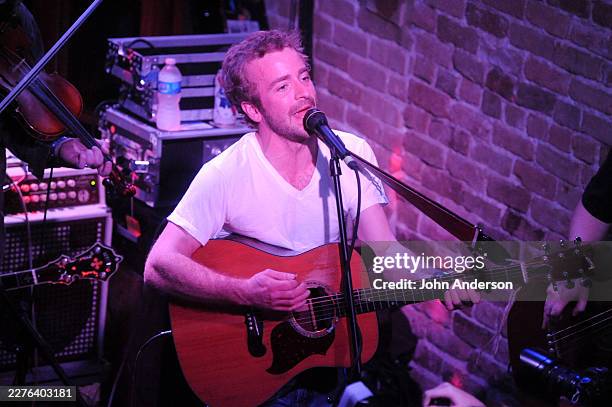 American Folk & Bluegrass musician Dave Simonett, of the group Trampled by Turtles, plays acoustic guitar as he performs, during South by Southwest...