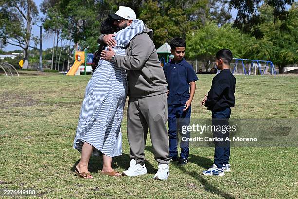 Family reunites with loved ones at the corner of Lindbergh Park next to the crime scene as law enforcement and emergency services respond to a...