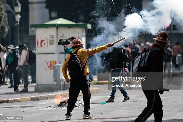 Miner fires a firecracker during clashes with police during clashes between protesters and police against the government of President Rodrigo Paz,...