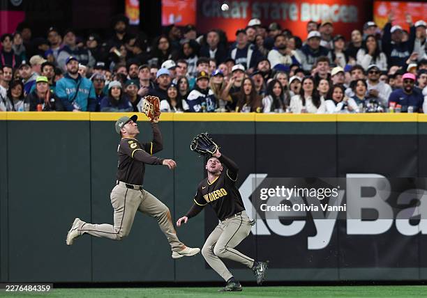 Ramon Laureano of the San Diego Padres and Jackson Merrill of the San Diego Padres run to catch a hit to the outfield during the fourth inning...