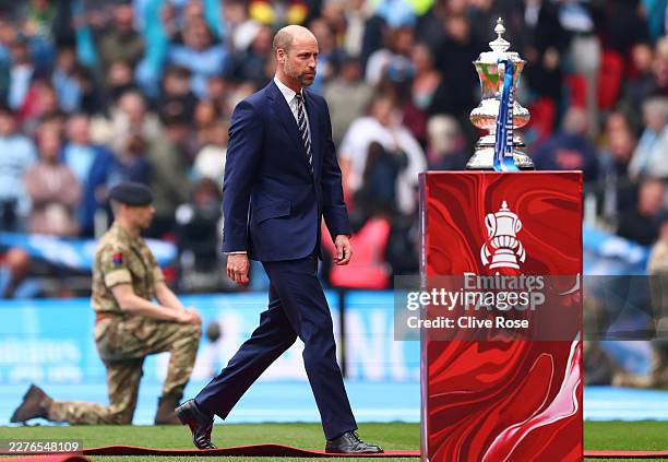 Prince William, Prince of Wales walks past the Emirates FA Cup Trophy prior to the Emirates FA Cup Final match between Chelsea and Manchester City on...