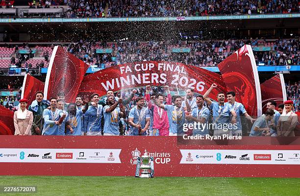 Players of Manchester City celebrate with the Emirates FA Cup trophy after their team's victory in the Emirates FA Cup Final match between Chelsea...