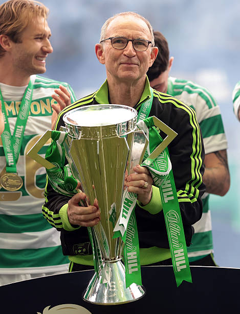 Martin O'Neill, Interim Manager of Celtic lifts the William Hill Premiership trophy with players of Celtic following the team's victory in the...
