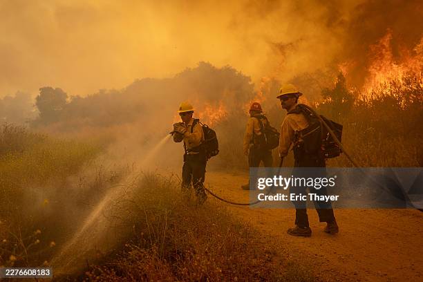 Simi Valley , CA Firefighters battle flames from the Sandy Fire in Runkle Canyon on Tuesday, May 19, 2026 in Simi Valley , CA.