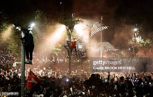 Arsenal fans celebrate their team winning the English Premier League, outside the Emirates Stadium in London on May 20, 2026. Arsenal celebrated...