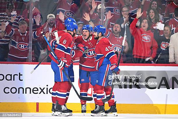 Jake Evans of the Montréal Canadiens celebrates with teammates after scoring a first period goal against the Buffalo Sabres in Game Six of the Second...
