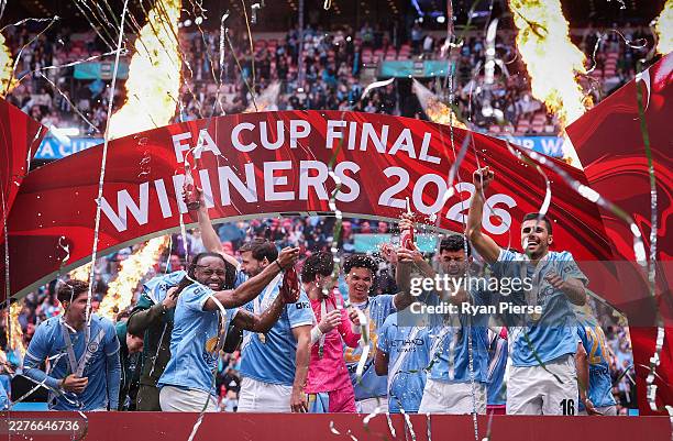Players of Manchester City celebrate with the Emirates FA Cup trophy after their team's victory in the Emirates FA Cup Final match between Chelsea...