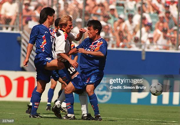 JUERGEN KLINSMANN OF GERMANY IS SURROUNDED BY JUNG BAE PARK AND YOUNG II CHOI OF SOUTH KOREA DURING GERMANY'S 3-2 VICTORY OVER SOUTH KOREA IN A 1994...