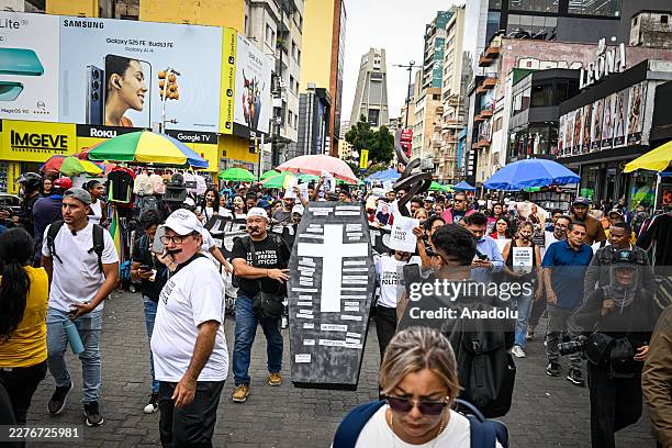Mothers, family members, students, and union workers march toward the headquarters of the Ministry of Popular Power for the Penitentiary Service...