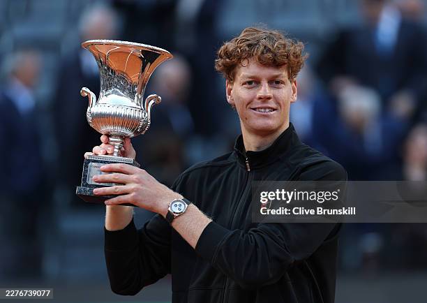 Jannik Sinner of Italy poses for a photo with the trophy following victory against Casper Ruud of Norway in their Men's Singles Final match on Day...