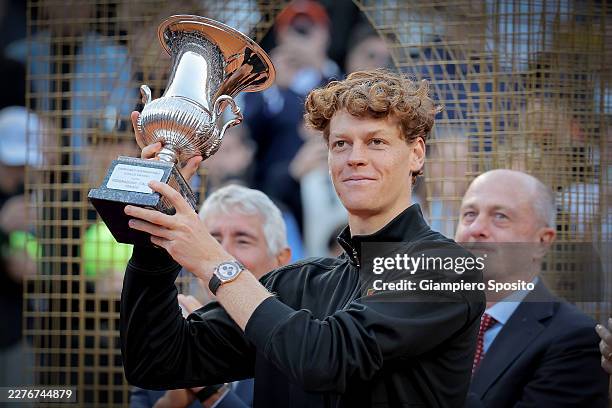 Jannik Sinner of Italy poses for a photo with the trophy following victory against Casper Ruud of Norway in their Men's Singles Final match on Day...