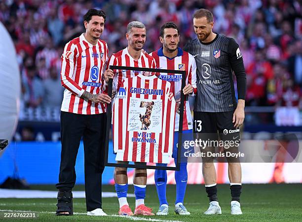 Jose Gimenez, Antoine Griezmann, Koke and Jan Oblak of Atletico de Madrid pose for a photo during a post match tribute to Antoine Griezmann after the...