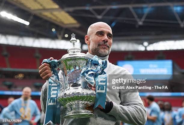 Pep Guardiola of Manchester City hold The FA Cup during the Emirates FA Cup Final match between Chelsea and Manchester City on May 16, 2026 in...