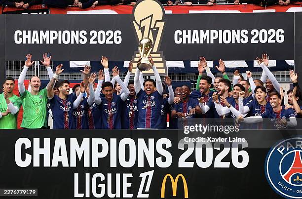Ousmane Dembélé, Marquinhos and Vitinha of Paris Saint-Germain celebrate with teammates and the Ligue 1 McDonald's Championship Trophy before the...