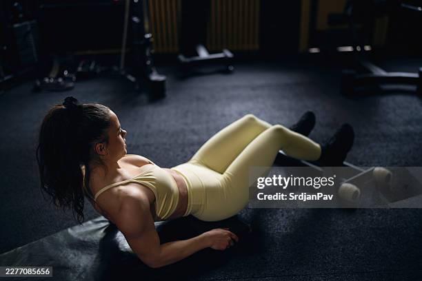 female athlete doing glute bridge hamstring curl - hamstring curl stock pictures, royalty-free photos & images