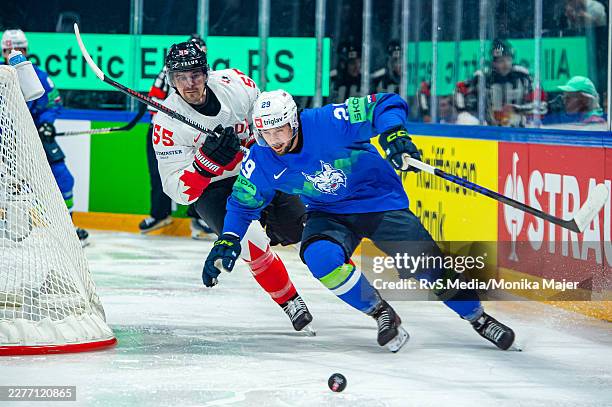 Aleksandar Magovac of Slovenia vies with Mark Scheifele of Canada during the 2026 IIHF Ice Hockey World Championship Switzerland game between Canada...