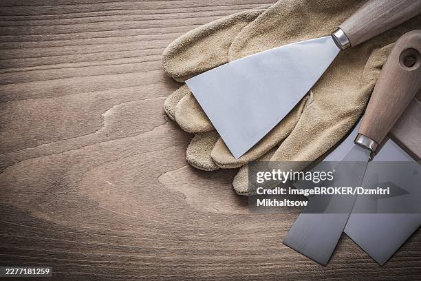 working glove putty knife paint scraper - paint scraper stock pictures, royalty-free photos & images