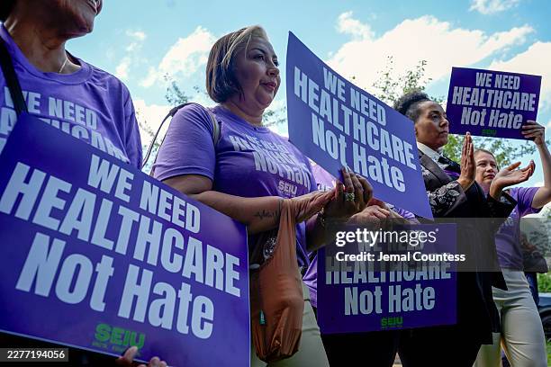 Attendees hold up signs during the SEIU rally where SEIU Members Called on Congress to Fund "Healthcare Not Hate" at the U.S. Capitol on May 19, 2026...