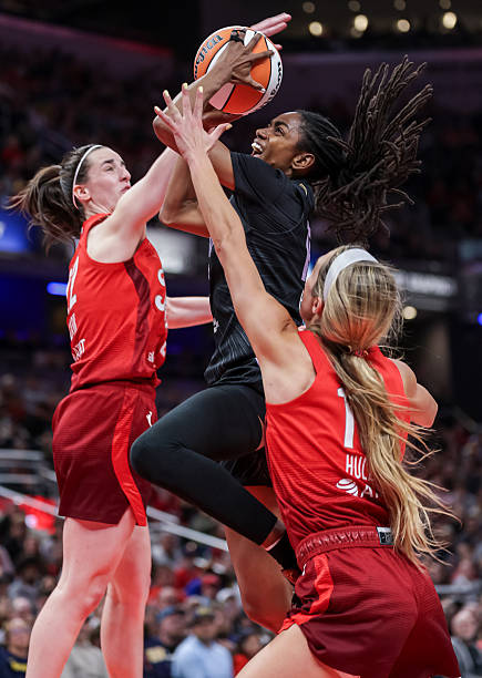 Tiffany Hayes of the Golden State Valkyries shoots the ball against Caitlin Clark of the Indiana Fever during the second half at Gainbridge...