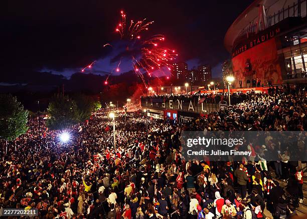 Arsenal fans celebrate winning the Premier League after Manchester City failed to win away to Bournemouth at Emirates Stadium on May 19, 2026 in...