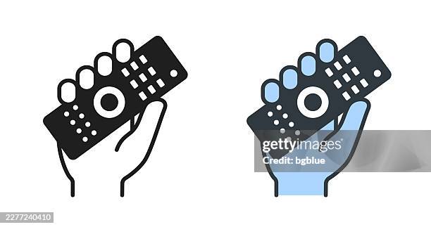 hand holding up remote control. icons for design - editable icon - holding remote control stock illustrations