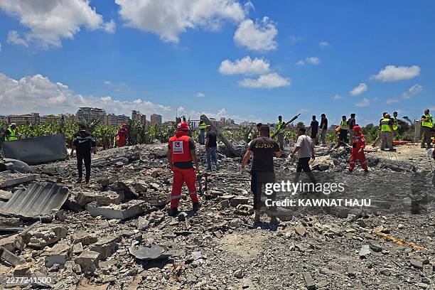 First responders gather at the site of an Israeli strike in Al-Aabbassiyah village near the southern Lebanese coastal city of Tyre on May 23, 2026....