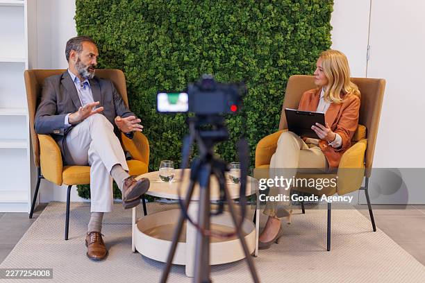 business people talking during a corporate interview in a modern studio - camera interview stock pictures, royalty-free photos & images