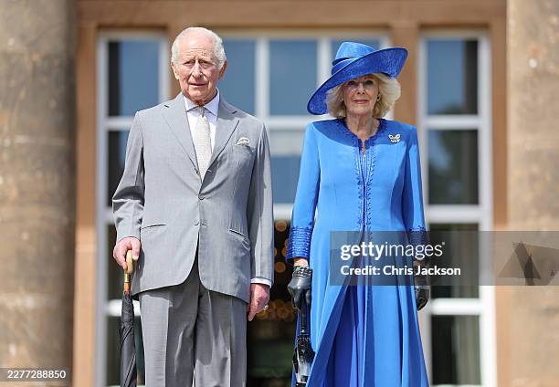King Charles III and Queen Camilla pose on the steps as they arrive at a Garden Party at Hillsborough Castle on May 20, 2026 in Hillsborough,...